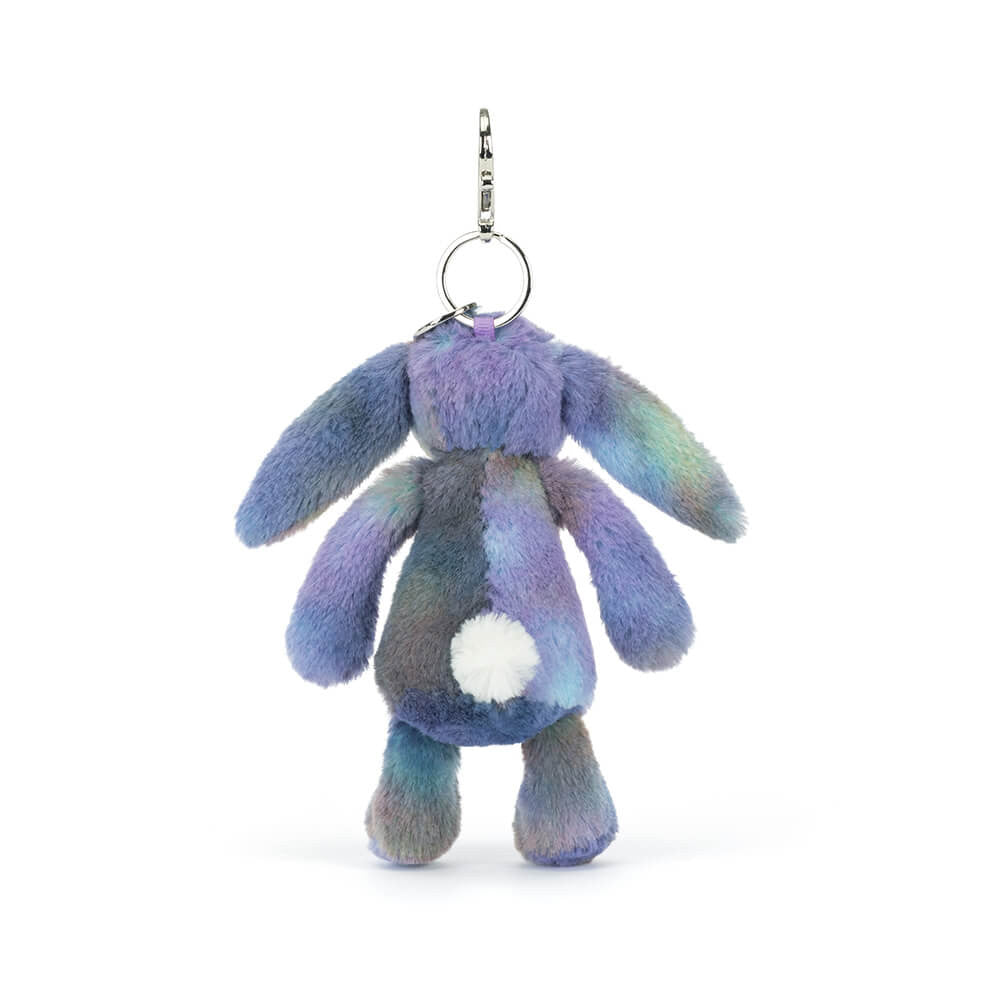 Back view of a plush bunny keychain with pastel space inspired colours on a white background.