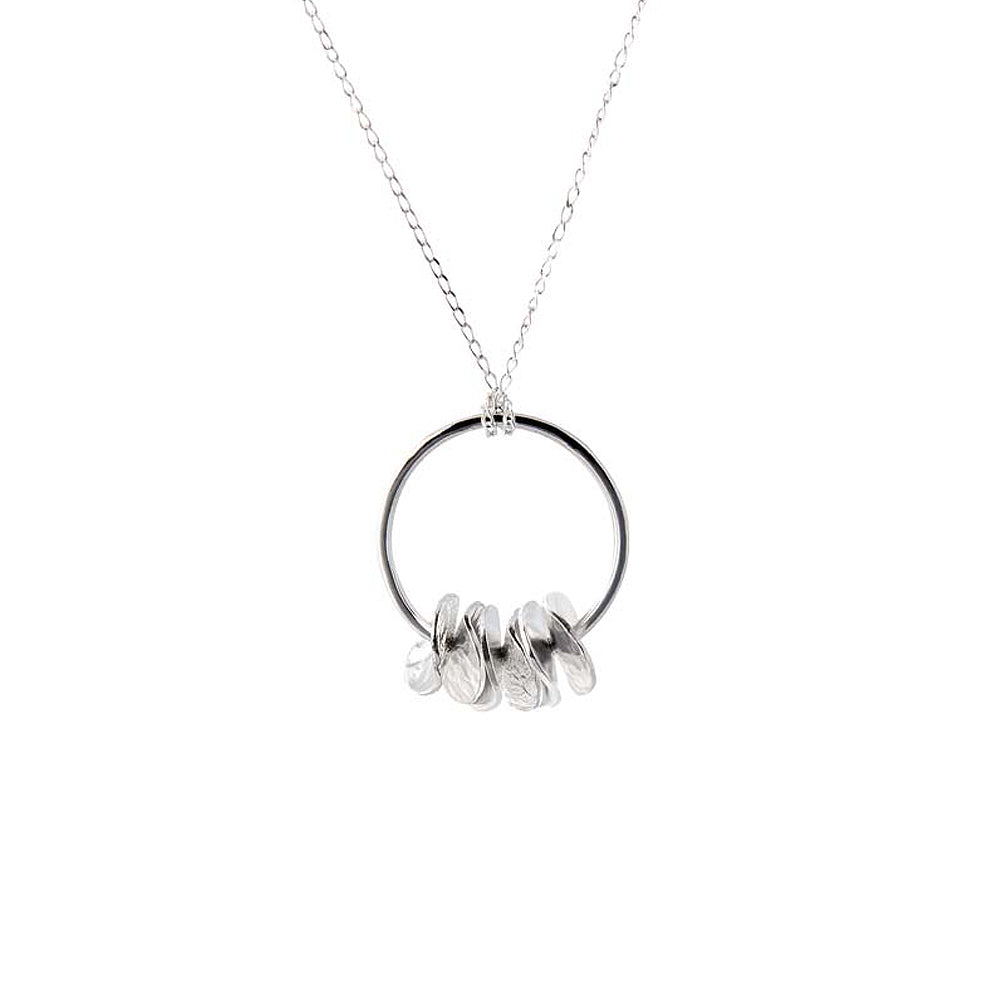 Silver pendant with overlapping disks on a hoop.