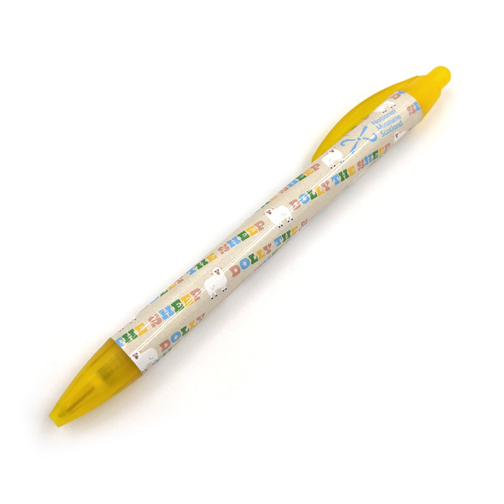A yellow plastic ballpoint pen with a pattern with illustrations of Dolly the sheep against a plain white background.