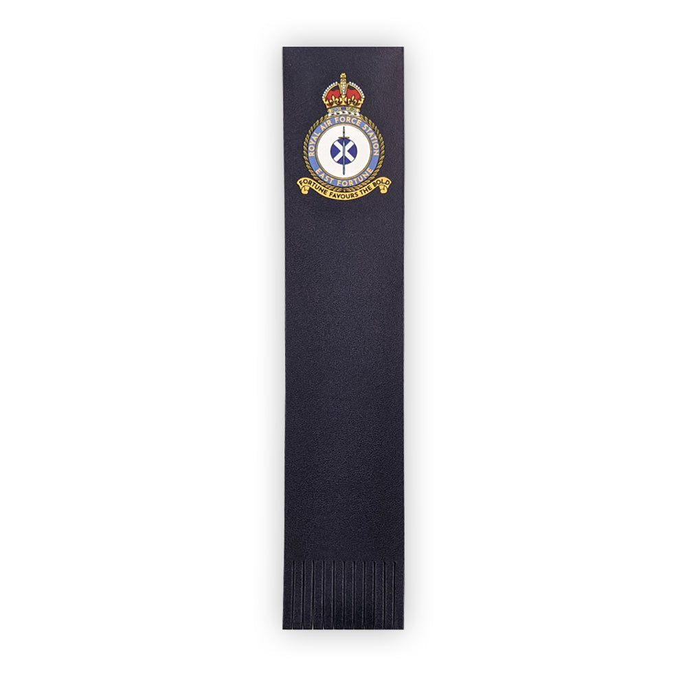 A navy blue leather bookmark with the East Fortune Royal Air Force badge at the top. A sword lays over a Saltire flag which sits in the centre of a round crest topped by a royal crown.