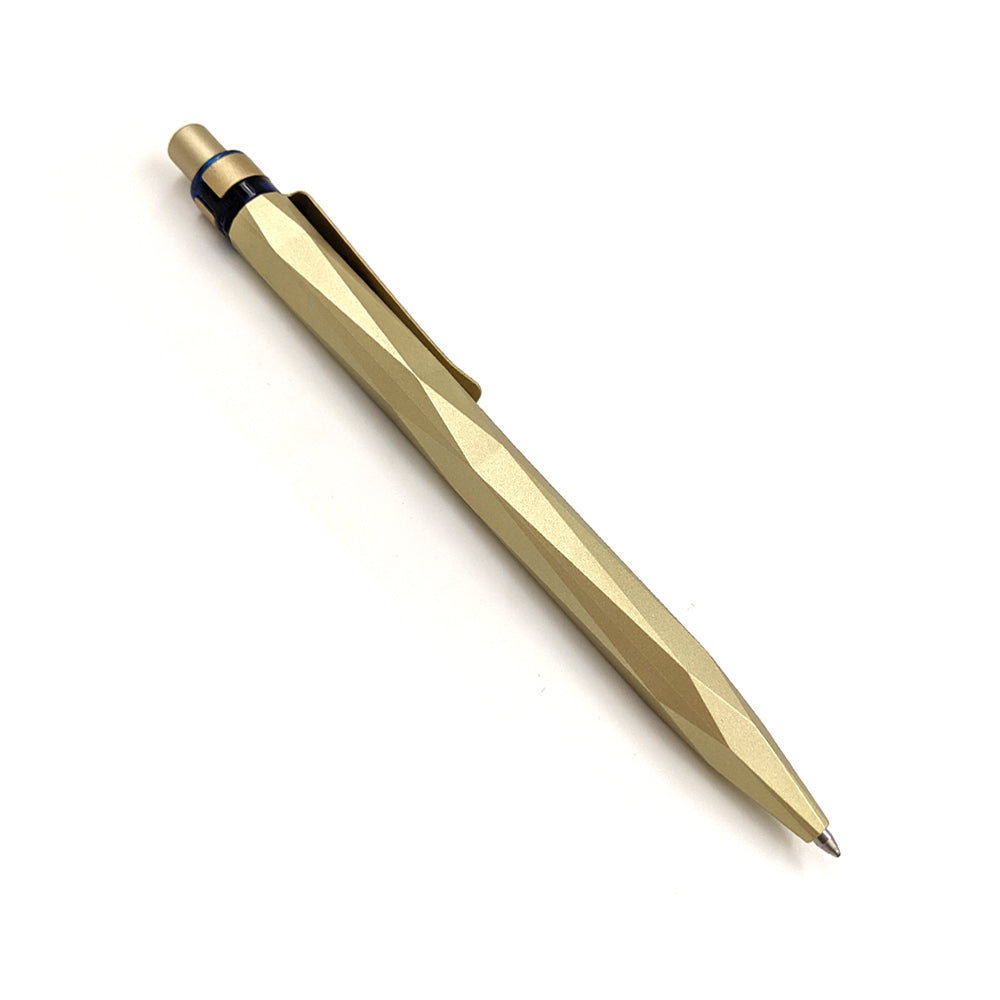 A gold pen with a smooth edged angular design and the National Museum of Scotland logo on the clip.