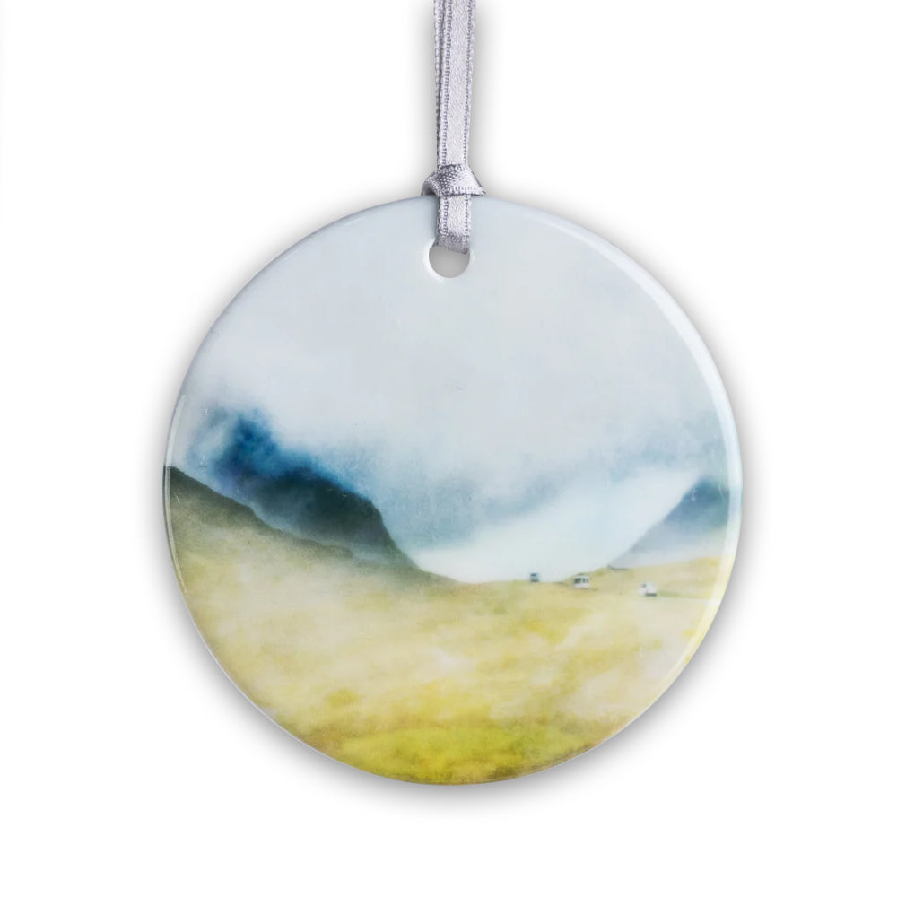 Round porcelain hanging decoration with a watercolour painting of a view of Glencoe.