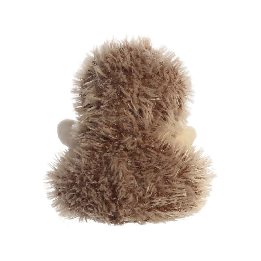 A reverse view of a small brown hedgehog soft toy with black beaded eyes and a brown plastic nose sitting against a plain white background.