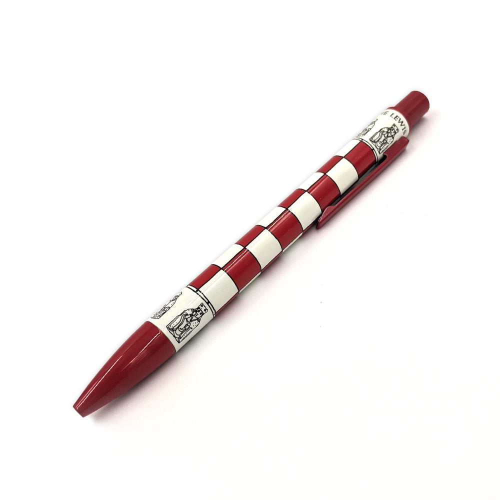 A red retractable ballpoint pen with a chess board pattern around the middle. Above and below the chessboard are line illustrations of the Lewis Chess pieces, the words "The Lewis Chessmen" circles the top edge of the body of the pen.