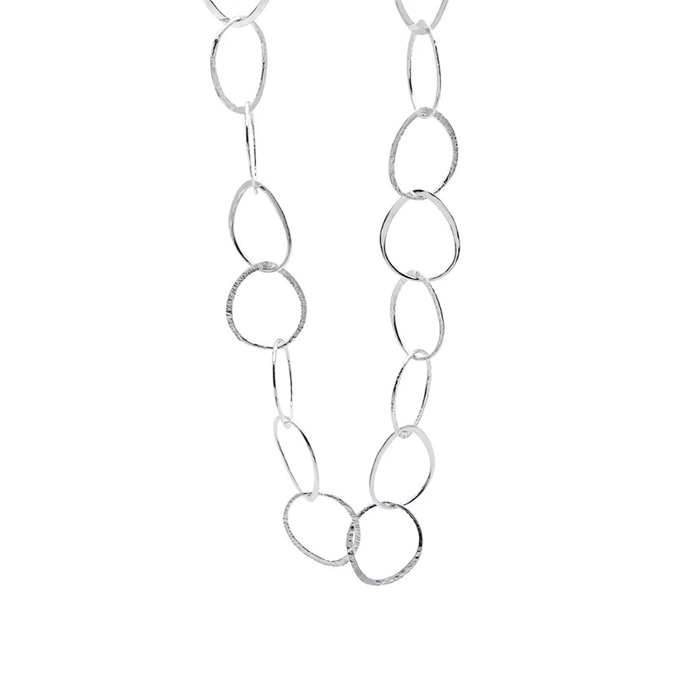 Silver necklace of large intertwining rings.