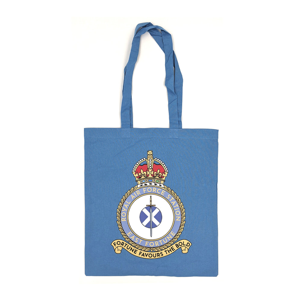 A pale blue tote bag with the East Fortune Royal Air Force badge. A sword lays over a Saltire flag which sits in the centre of a round crest topped by a royal crown.
