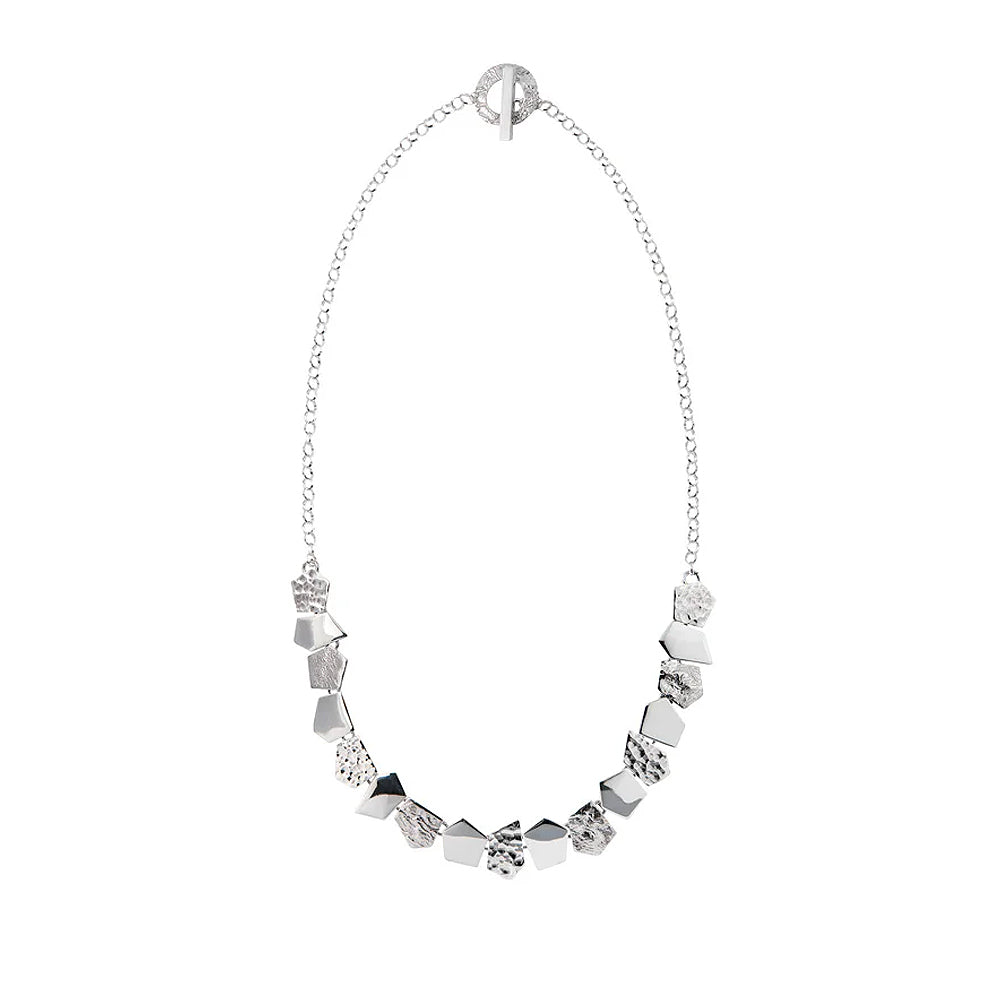 Silver necklace with textured pentagonal detailing.