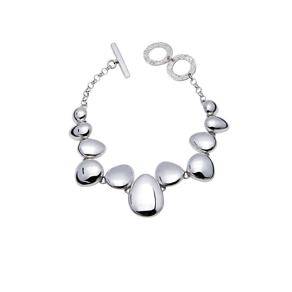 Silver bracelet with polished pebble like detailing.