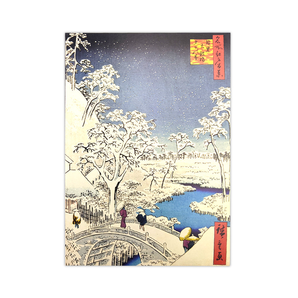 A Christmas card with a Japanese woodcut print of a bridge in a wooded snowy scene.