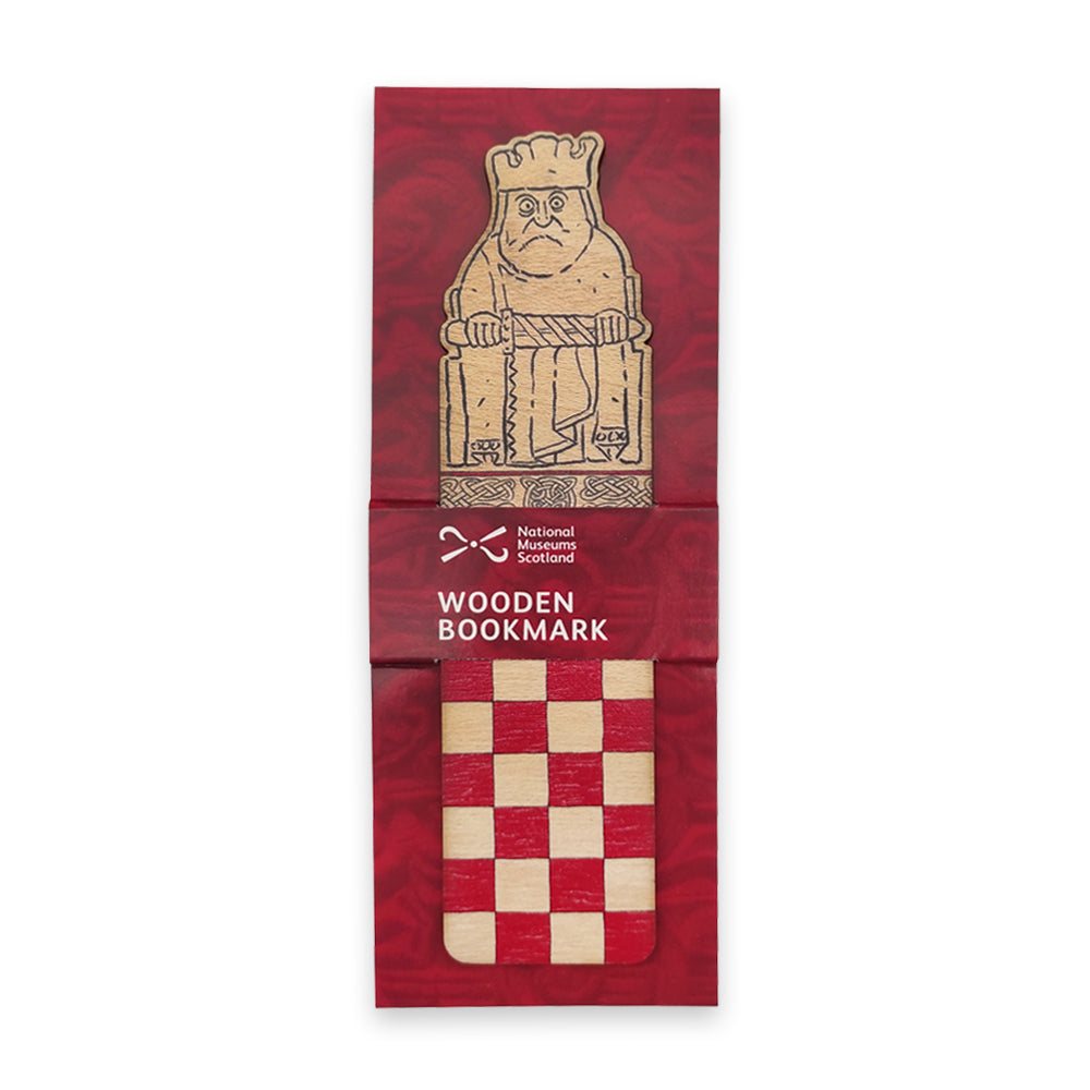 A wooden bookmark with the top half illustrated with a king Lewis chess piece and the bottom half with a red chessboard style grid on a maroon backing card.