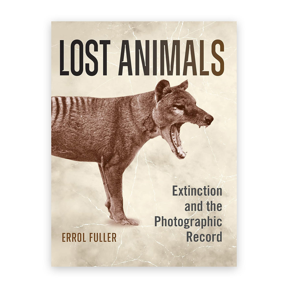 A book cover with a an old sepia tone photograph of a thylacine against a smoky background. The words 'lost animals' run across the top of the cover in a large sans serif font.