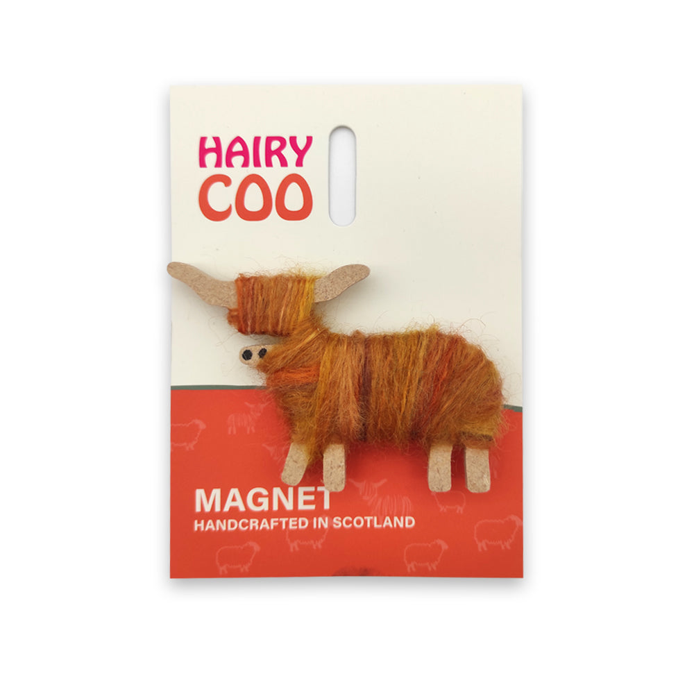 An orange wool and wooden highland cow magnet on a backing card with the words 'Hairy Co' across the top