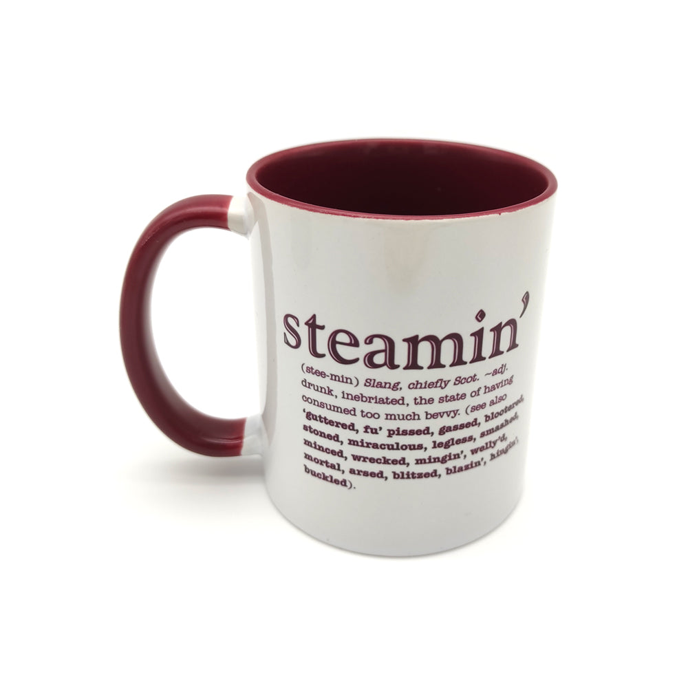 White mug with a maroon inside and handle against a plain white background. The mug is printed with the word steamin' and its definition in maroon.