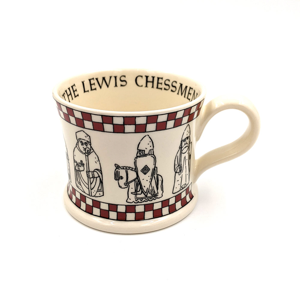 A round ceramic mug with line illustrations of the Lewis chess pieces. There is a red chess board pattern along the whole of the top and bottom outer edge. The words "The Lewis Chessmen" is along the inside of the upper edge.