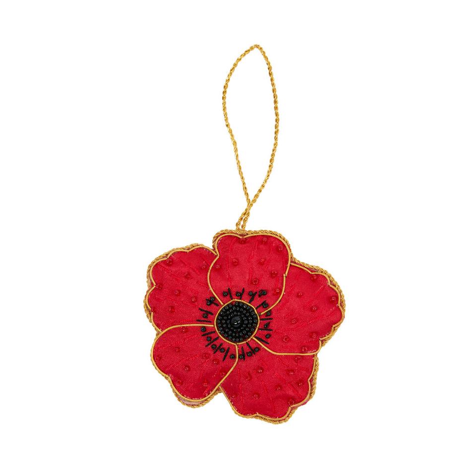 An embroidered hanging decoration of a poppy. The decoration is made from red fabric and is embroidered with gold thread and black beads.
