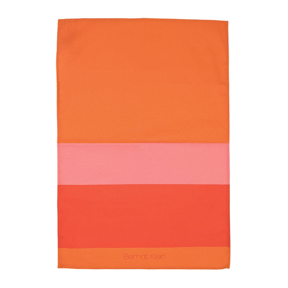 An orange and pink striped cotton tea towel based on Bernat Klein's work against a plain white background.