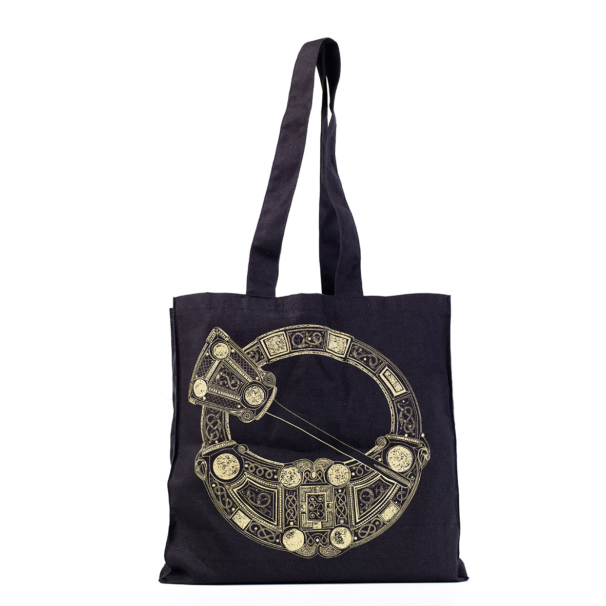 A black cotton tote bag with printing of the Hunterston brooch in gold. The brooch's pin sits across an opening in the centre of the round brooch, Norse knot work and beads are features on the surrounding ring.