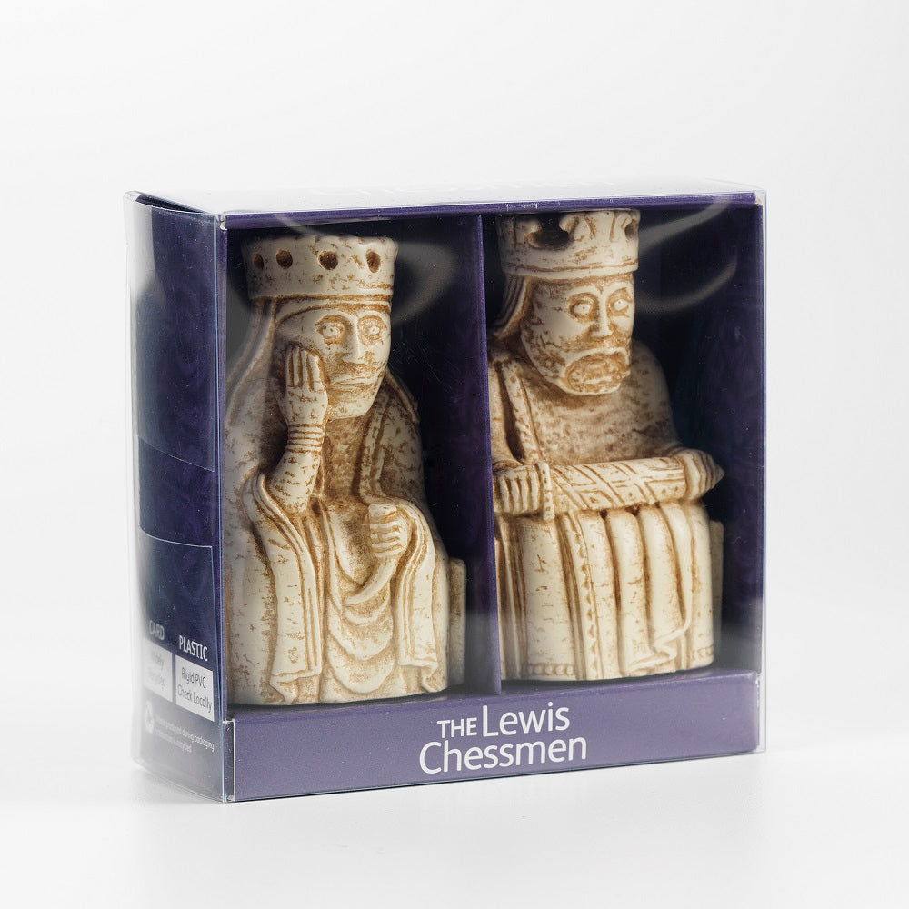 A purple cardboard box with a cellophane window with a resin replica of a queen Lewis chess piece and a king Lewis chess piece.