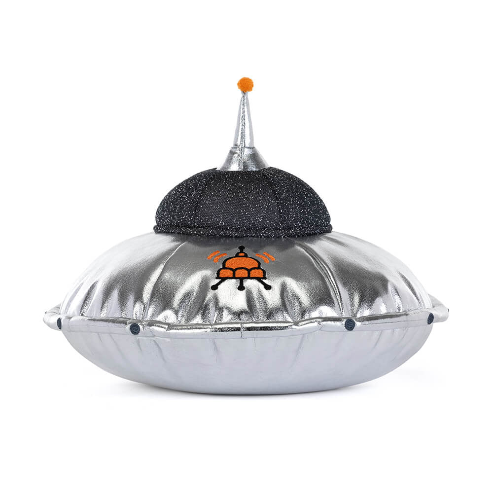 A back view of a soft toy of a shiny silver flying saucer with legs and a smiley face against a plain white background.