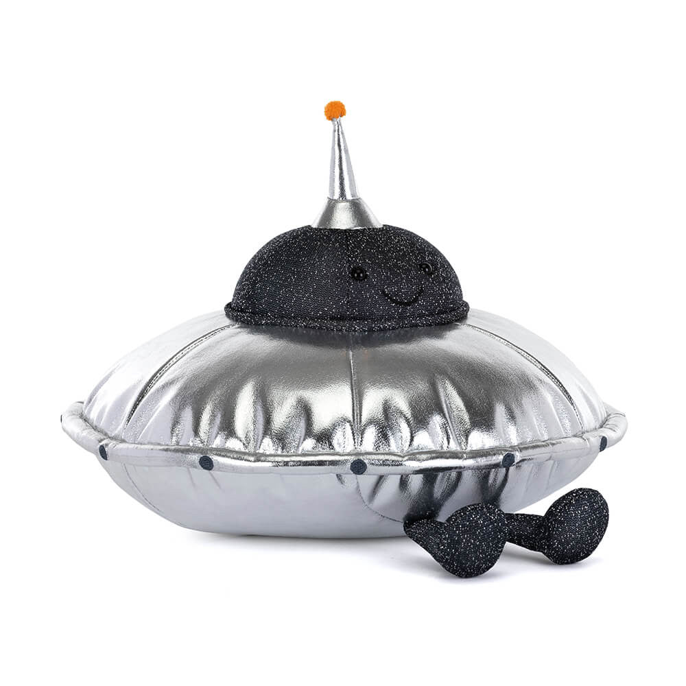 A soft toy of a shiny silver flying saucer with legs and a smiley face against a plain white background.