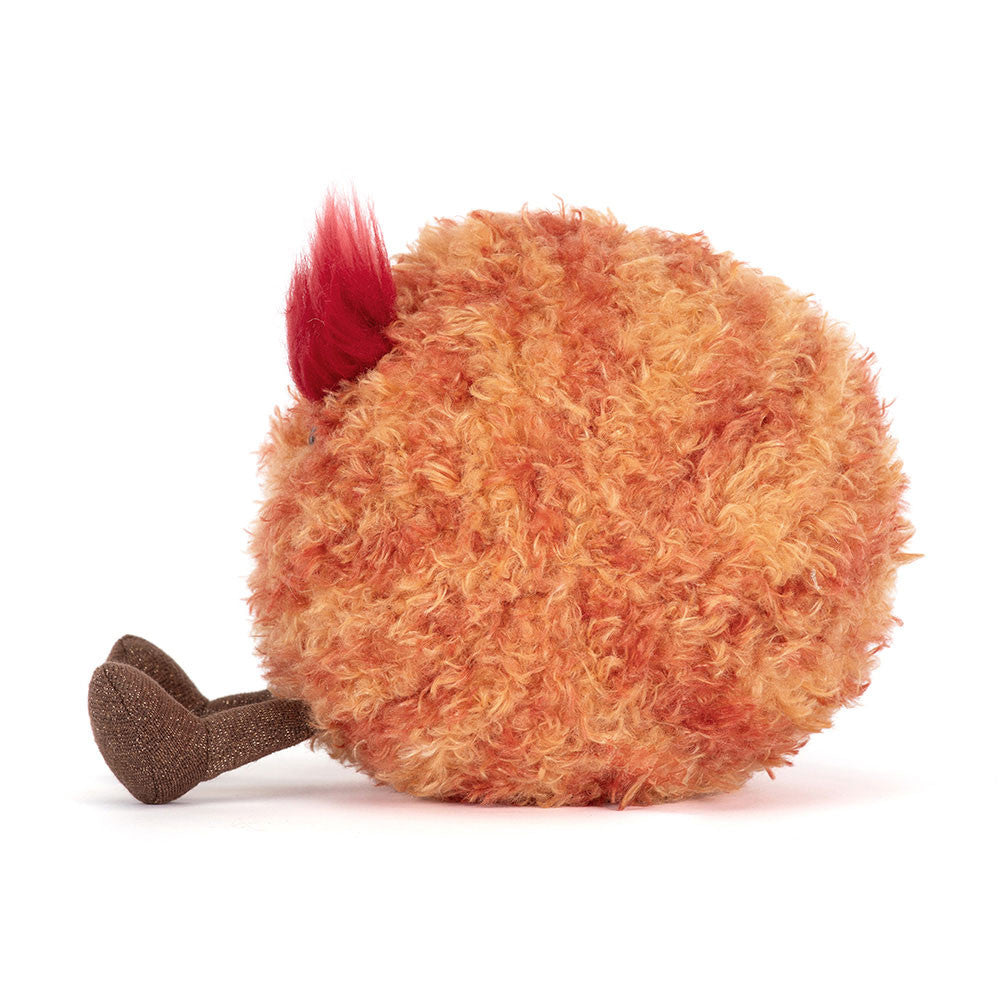 Side view of a soft toy planet mars with a frowning face and large red fluffy eyebrows and brown legs against a white background.