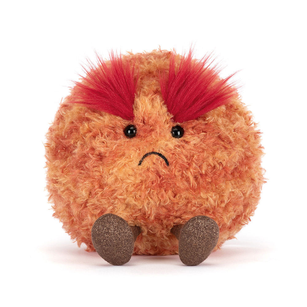 A soft toy planet mars with a frowning face and large red fluffy eyebrows and brown legs against a white background.