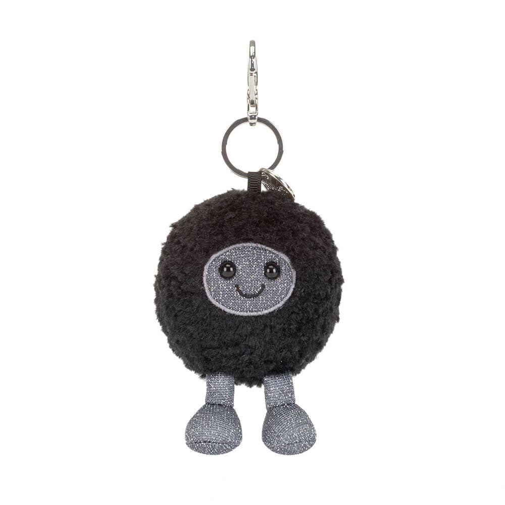 Black round plush keychain with a smiling face and grey legs on a white background