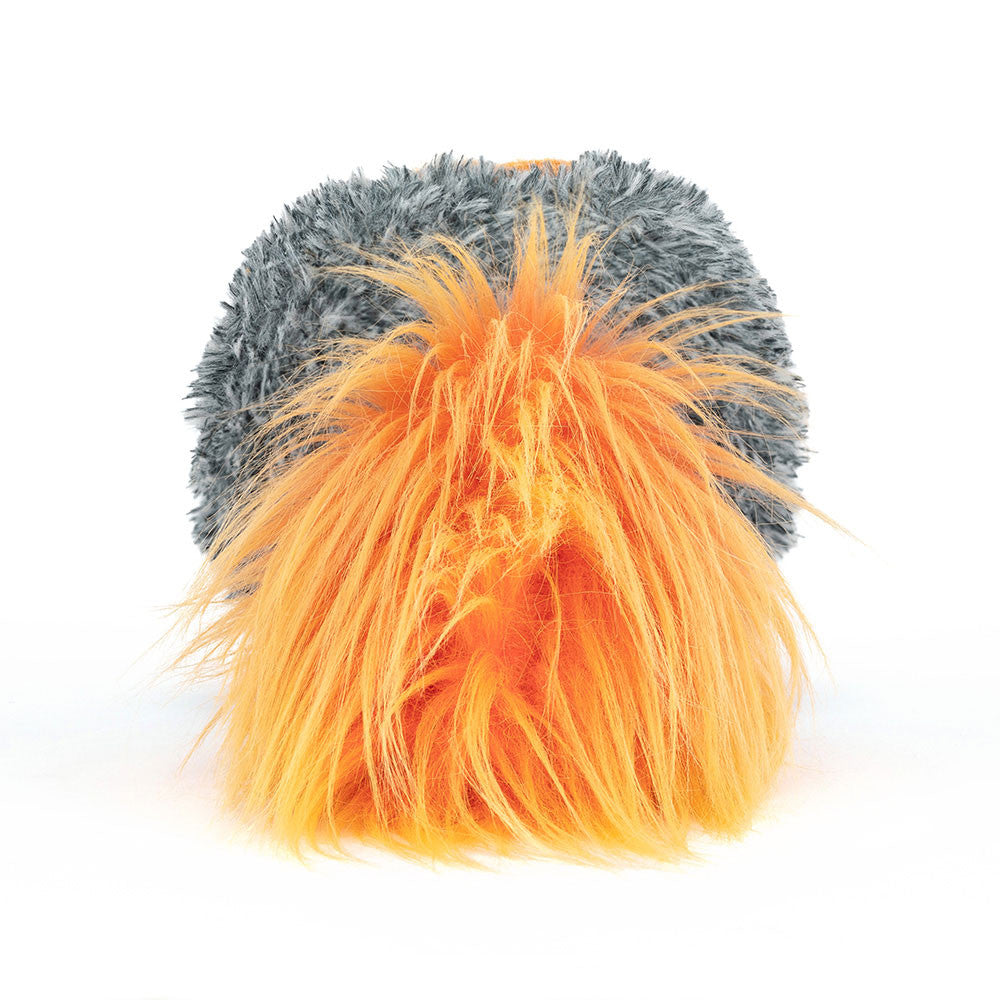Back view of a soft toy of a flaming comet with a smiley face, yellow legs and an orange fluffy trail of faire against a white background.