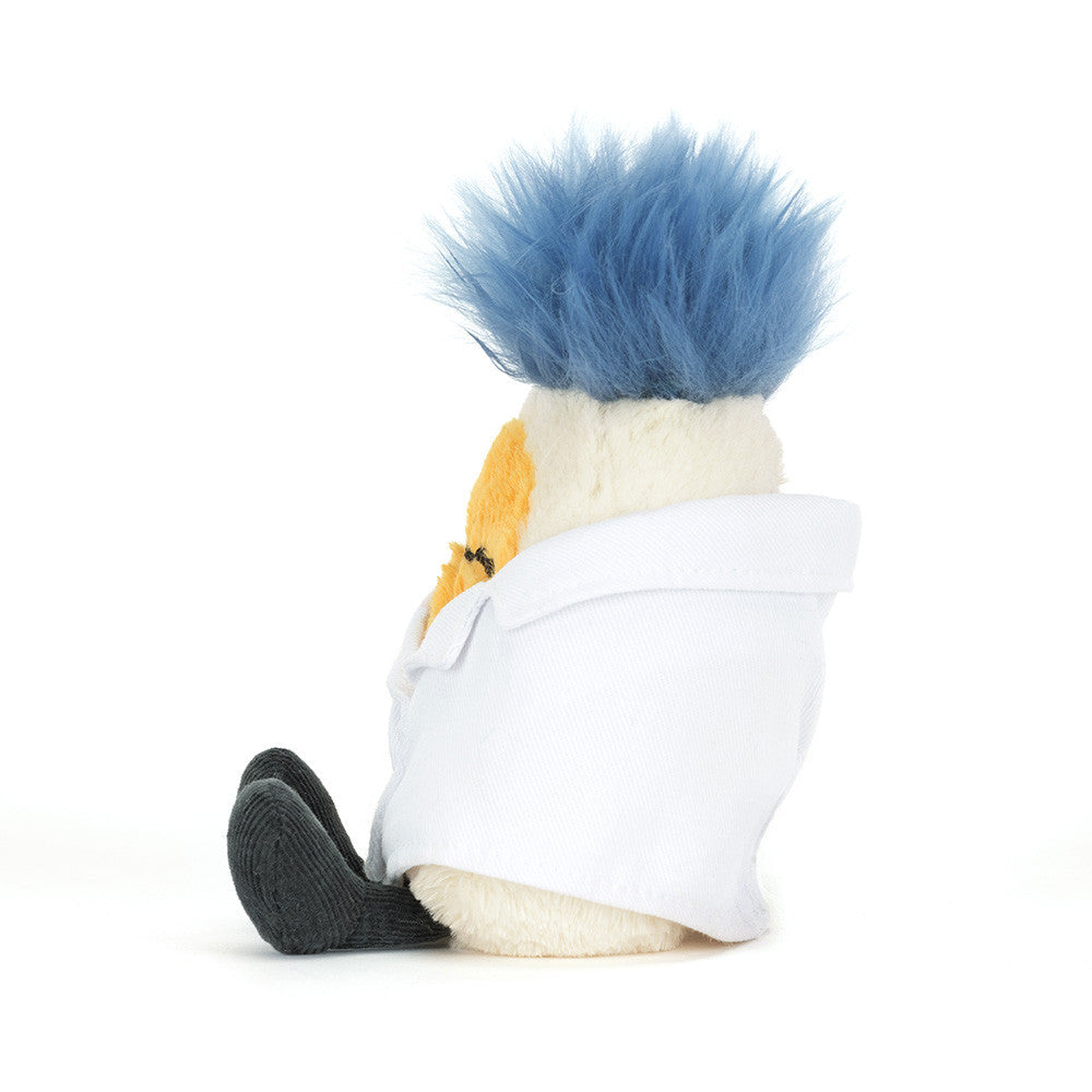 A side view of a stuffed toy resembling a scientist with blue hair, glasses and a white lab coat on a white background