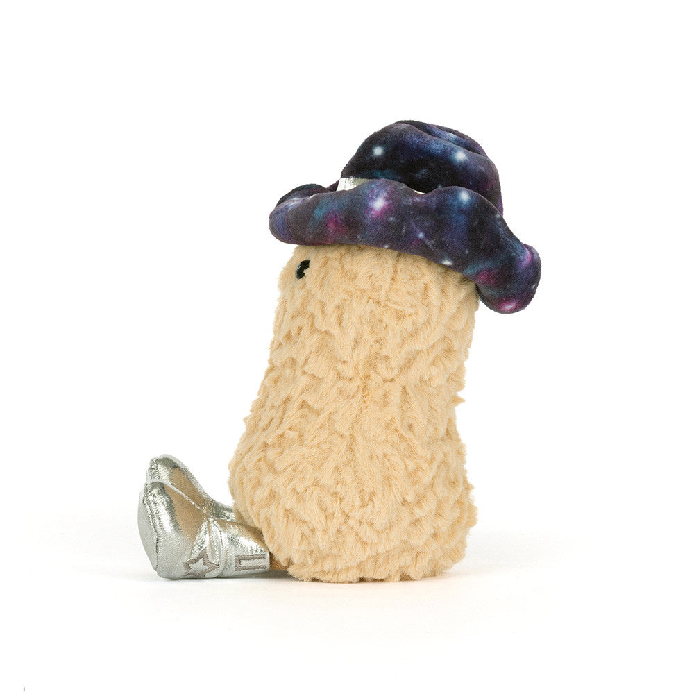 A side view of a stuffed toy peanut with a smiling face, a galaxy-patterned hat and silver shoes on a white background