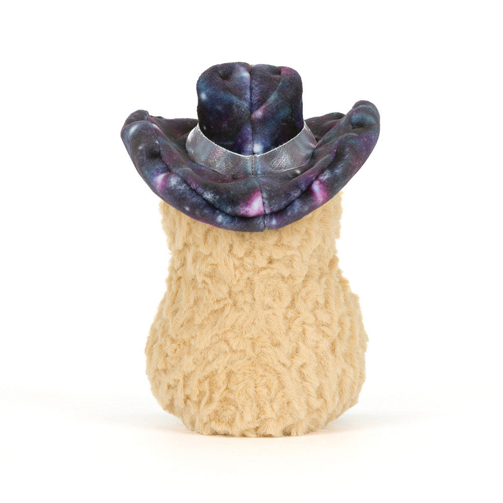 A back view of a stuffed toy peanut with a smiling face, a galaxy-patterned hat and silver shoes on a white background