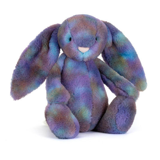 Multicoloured plush bunny toy in space inspired colours on a white background
