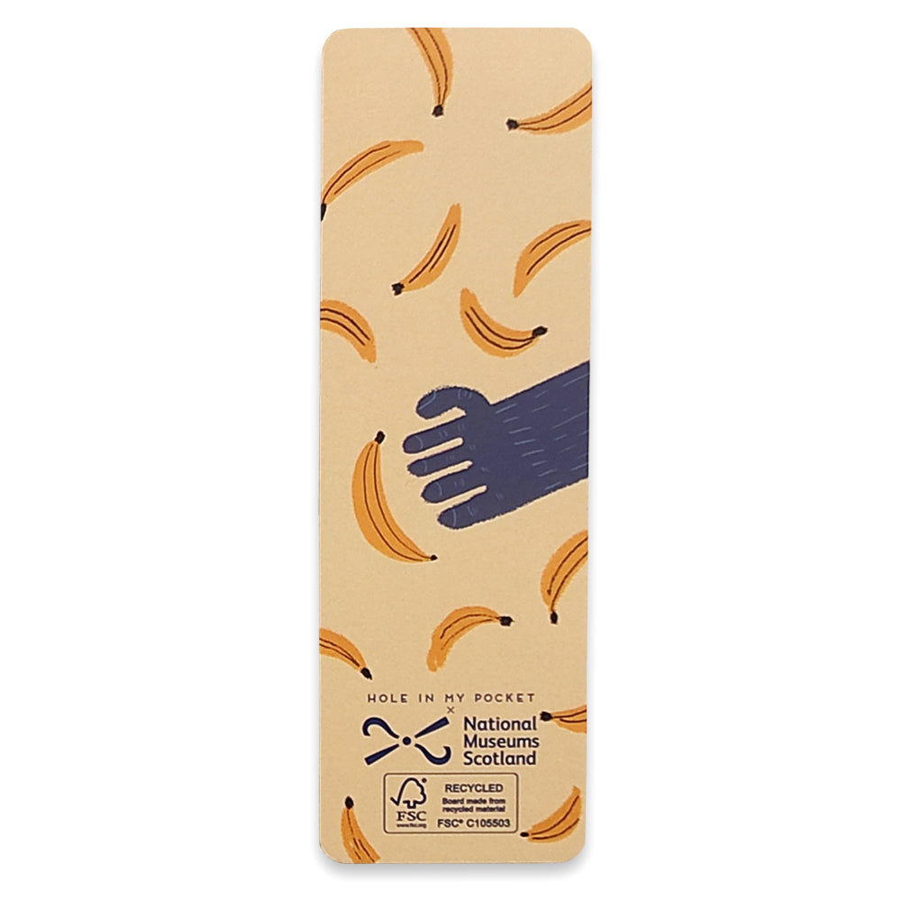 A paper bookmark with an illustration or a gorilla's hand reaching for bananas.