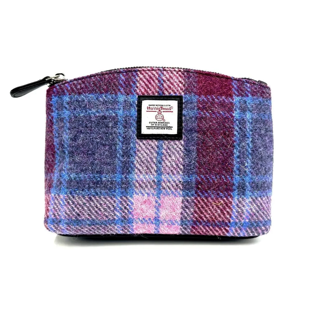 Blue Harris tweed cosmetic bag with a black vegan leather zipper.