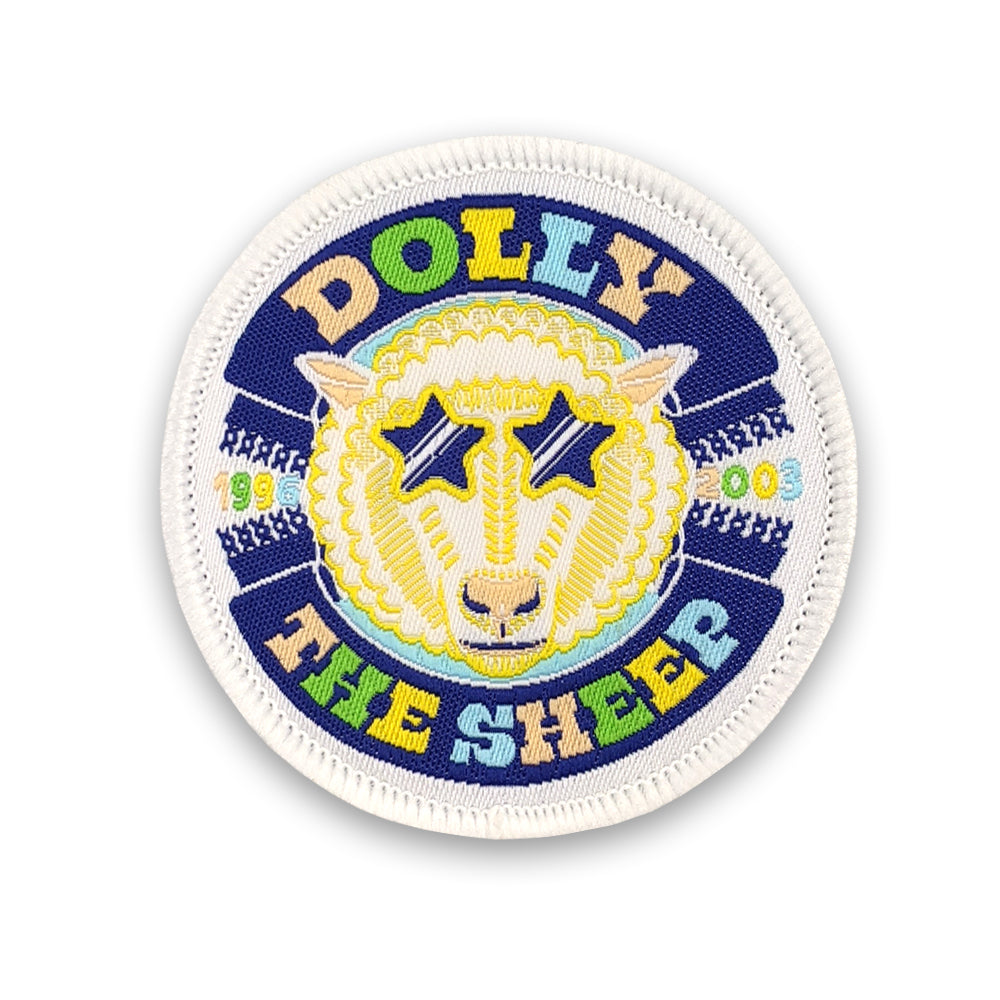 A round embroidered patch with a colourful design of Dolly the sheep against a plain white background.