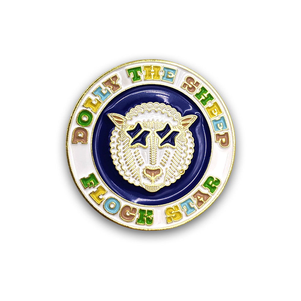 A round enamel pin badge with a colourful design of Dolly the sheep against a plain white background.