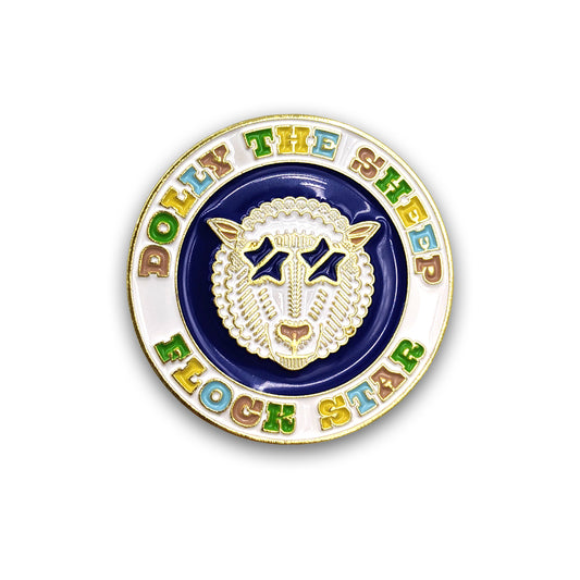 A round enamel pin badge with a colourful design of Dolly the sheep against a plain white background.