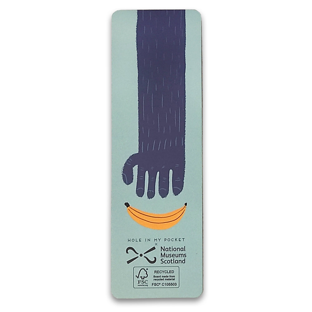 A paper bookmark with an illustration of a gorillas arm reaching for a banana.