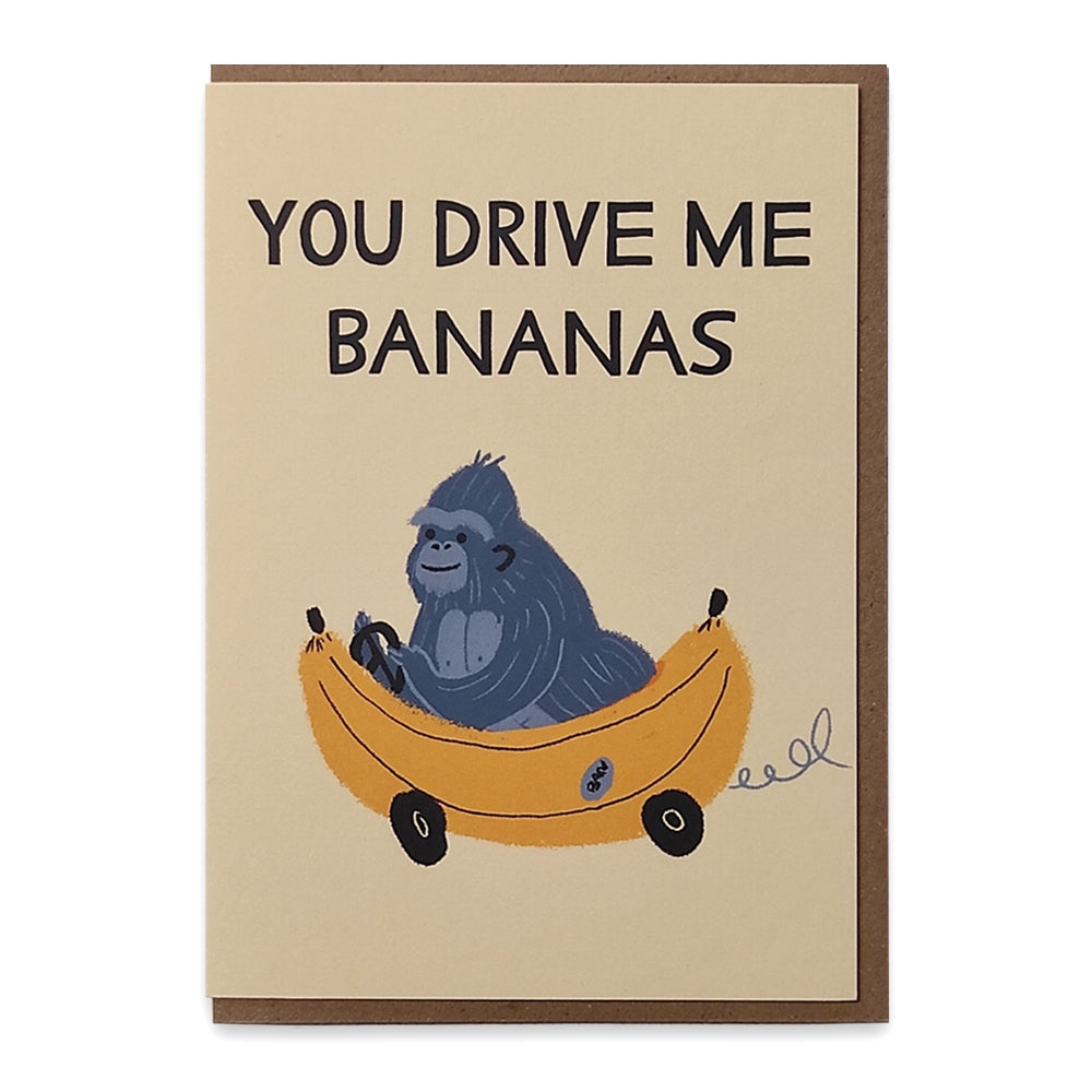 A photograph of a greetings card with an illustration of a gorilla driving a car that looks like a banana, above the gorilla are the words "You drive me bananas".