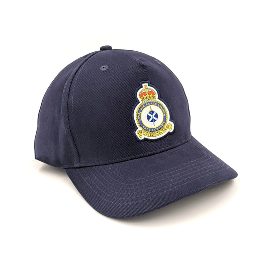A navy blue cap with an embroidered East Fortune Royal Air Force badge. A sword lays over a Saltire flag which sits in the centre of a round crest topped by a royal crown.