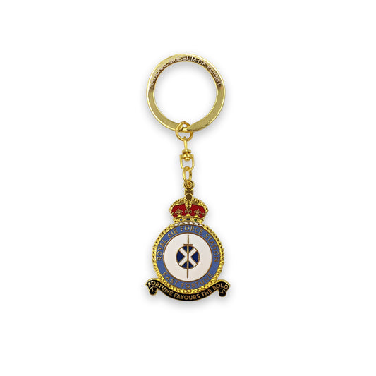 A metal key ring of the East Fortune Royal Air Force badge. A sword lays over a Saltire flag which sits in the centre of a round crest topped by a royal crown.