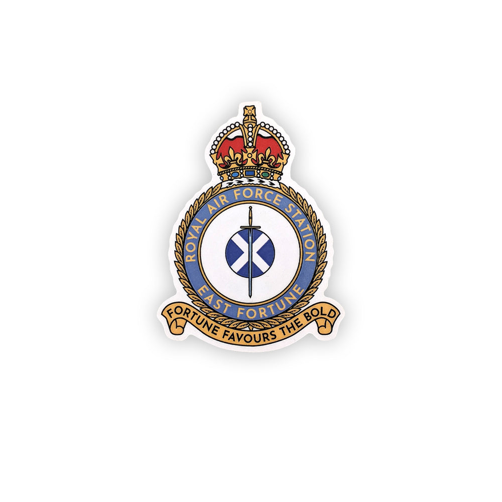 A wooden cut out magnet of the east fortune Royal Air Force badge. A sword lays over a Saltire flag which sits in the centre of a round crest topped by a royal crown.