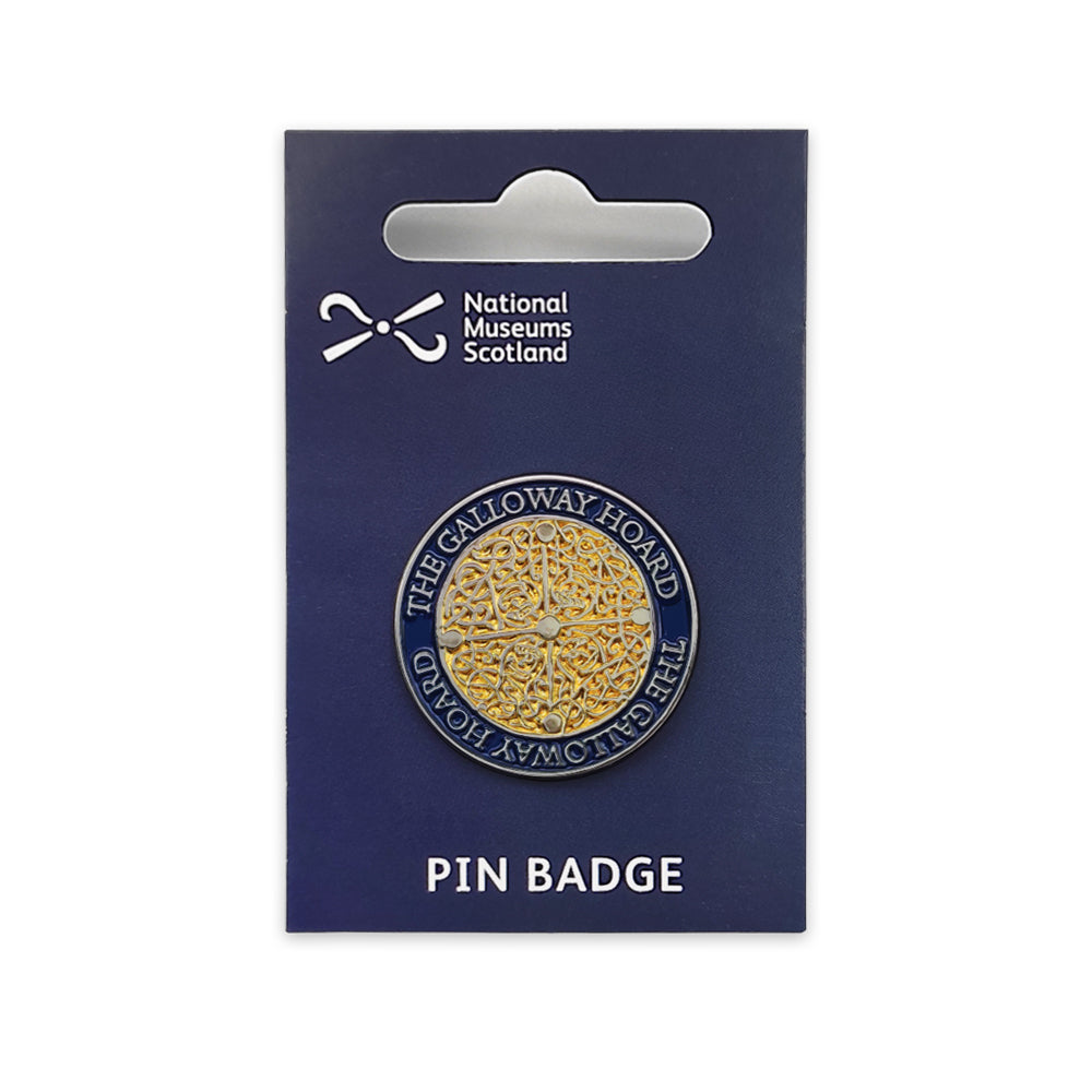 A round gold and blue pin badge on a navy blue backing card against a plain white background