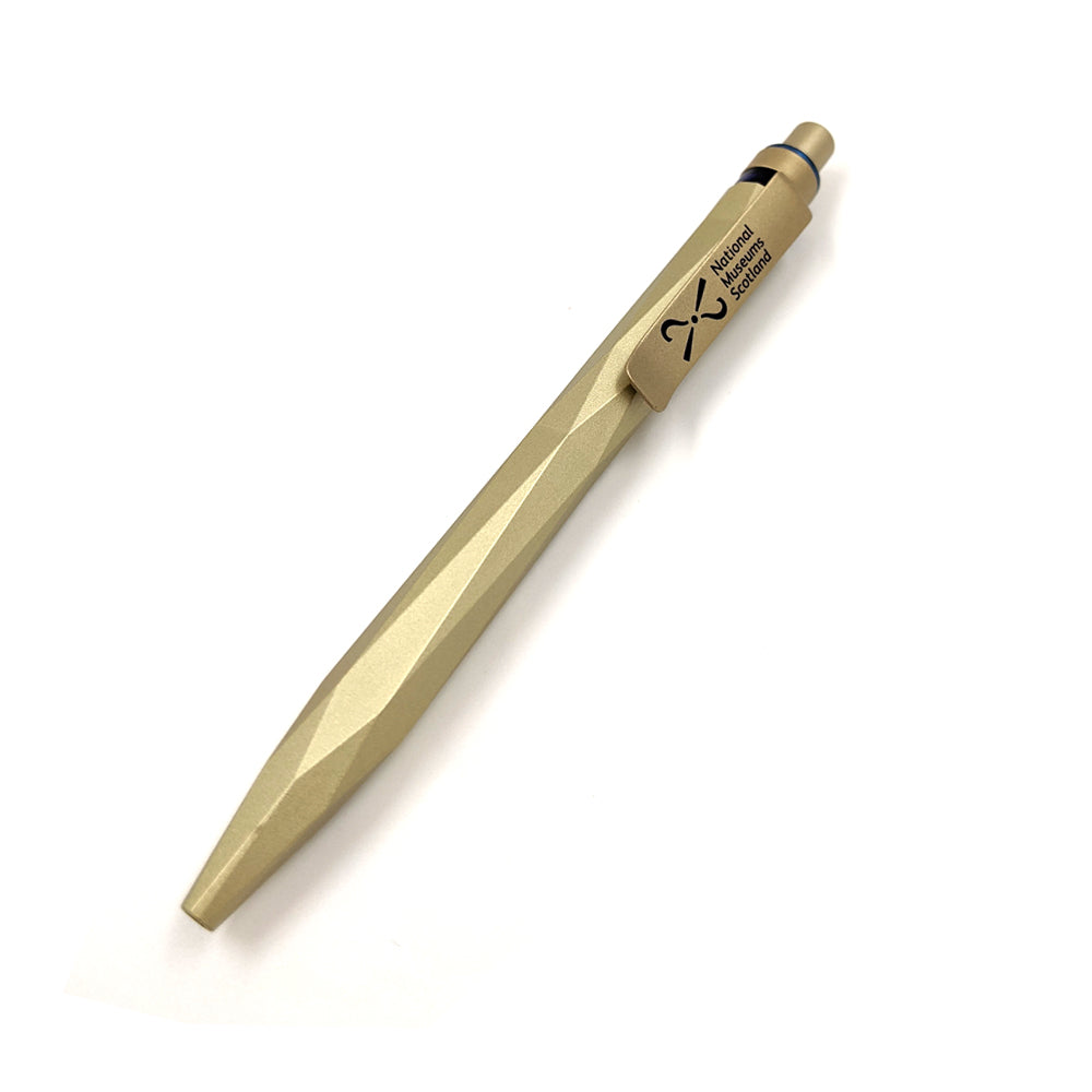 A gold pen with a smooth edged angular design and the National Museum of Scotland logo on the clip.