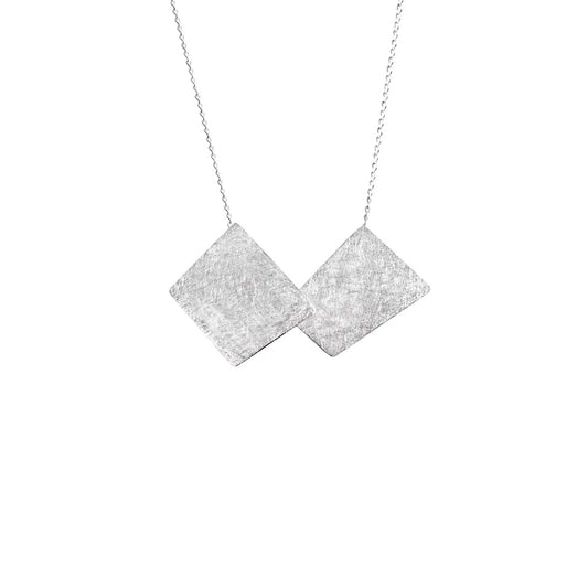 Silver pendant with textured geometric detailing.