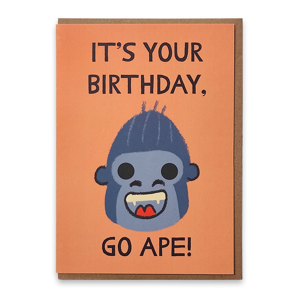 A photograph of a greetings card with an illustration of a smiling gorilla face against an orange background with the words "It's your birthday, go ape!" surrounding it.