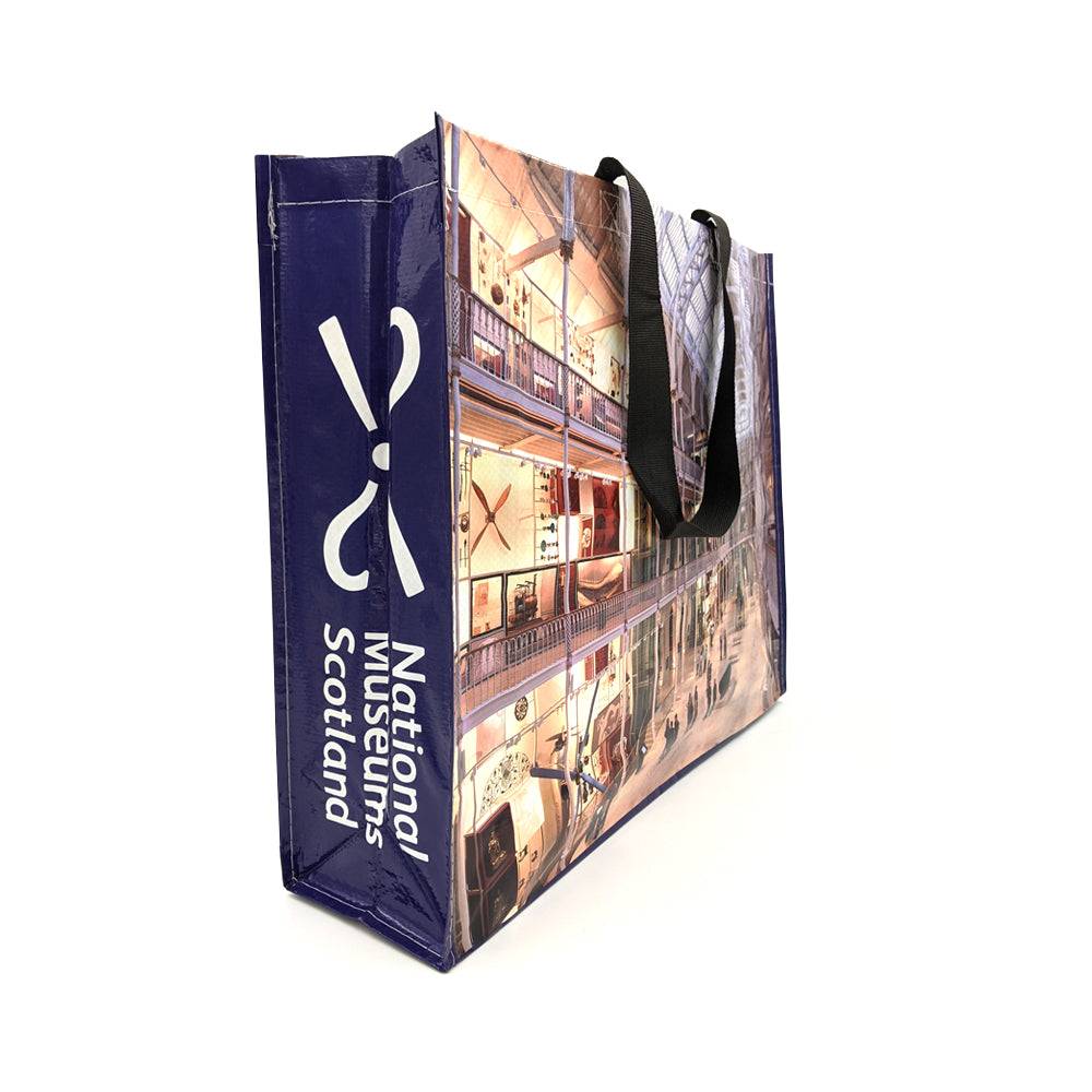 A reusable bag with a photograph of the National Museum of Scotland's Grand Gallery, and the National Museum of Scotland's logo down the side.