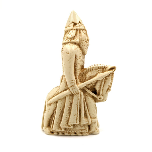 A plastic resin replica magnet of a knight Lewis chess piece. A knight on a horse facing right, the knight is wearing a pointed hat and holding a large spear.