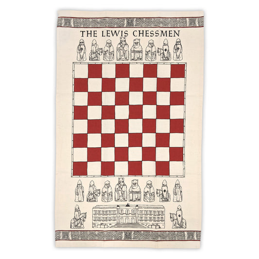 A cream tea towel. In the middle of the towel there is a red and cream chess board design above and below the chess board are line illustrations of the Lewis chessmen. Above the top row of Lewis chessmen are the words "The Lewis Chessmen" and underneath the bottom row is a line illustration of the National Museum of Scotland flanked either side by line illustrations of knight Lewis Chessmen. The top and bottom edge of the towel are decorated with a row of knot work designs.