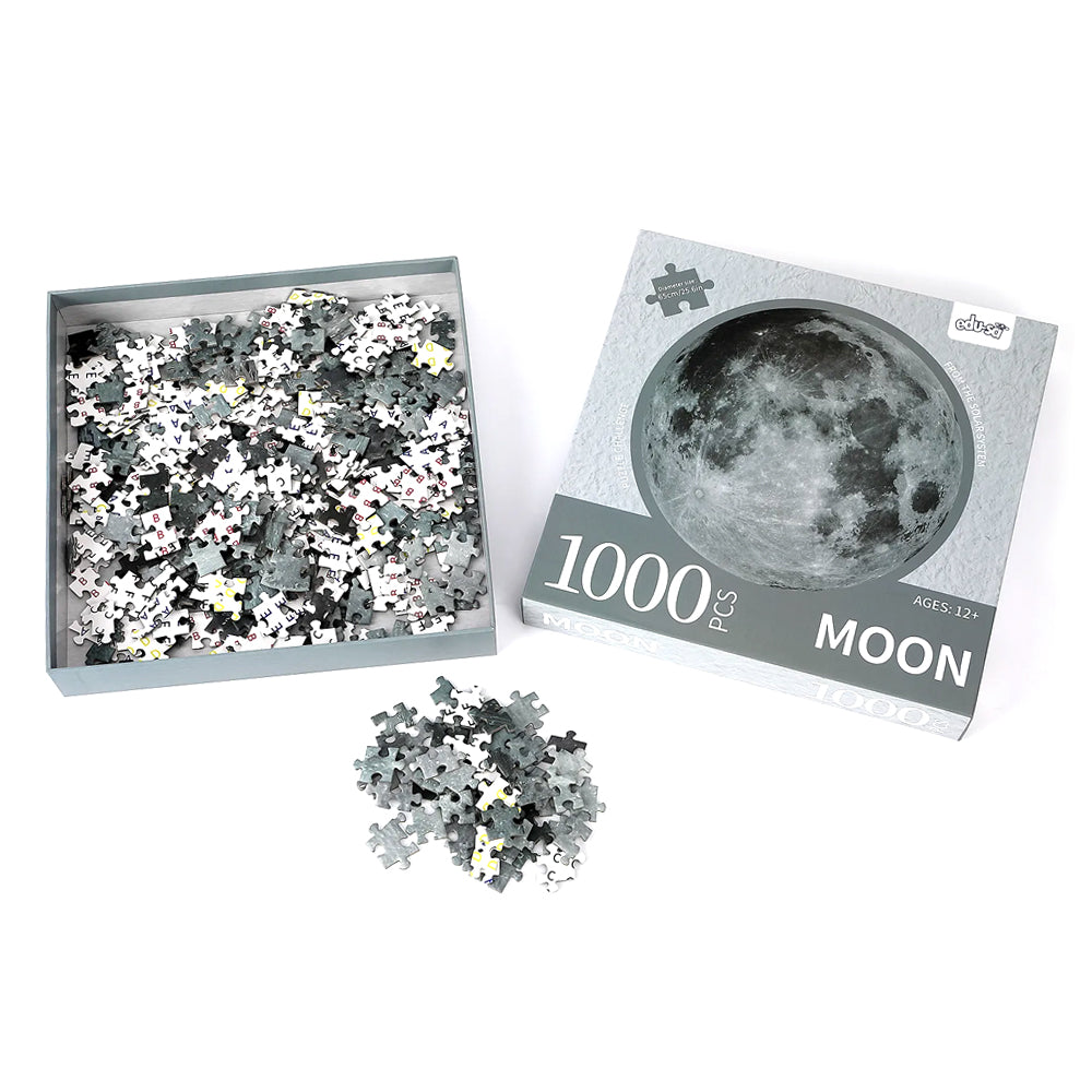 Jigsaw box opened with a selection of pieces scattered.